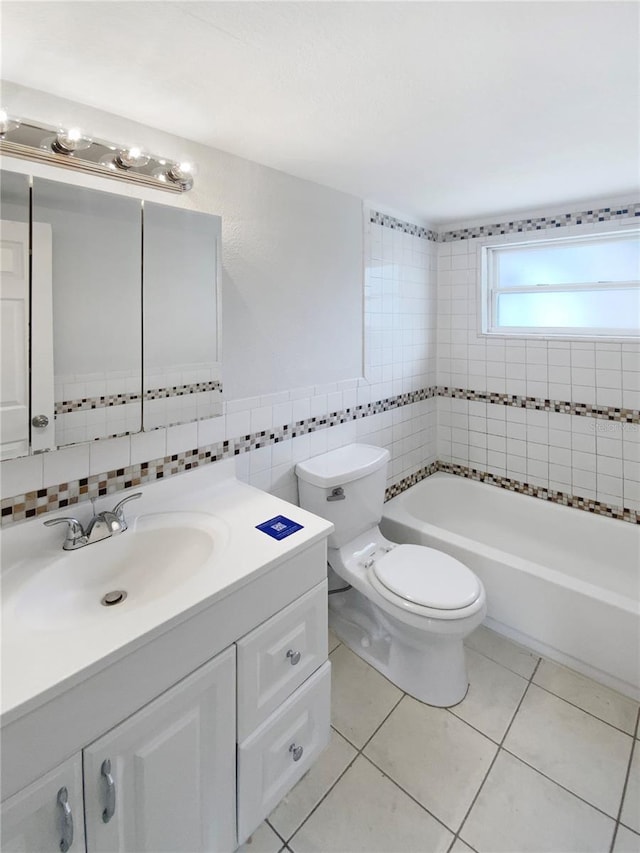 bathroom with vanity, tile patterned flooring, toilet, tile walls, and a tub