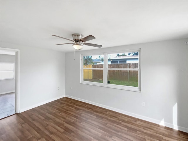 empty room featuring dark hardwood / wood-style floors and ceiling fan