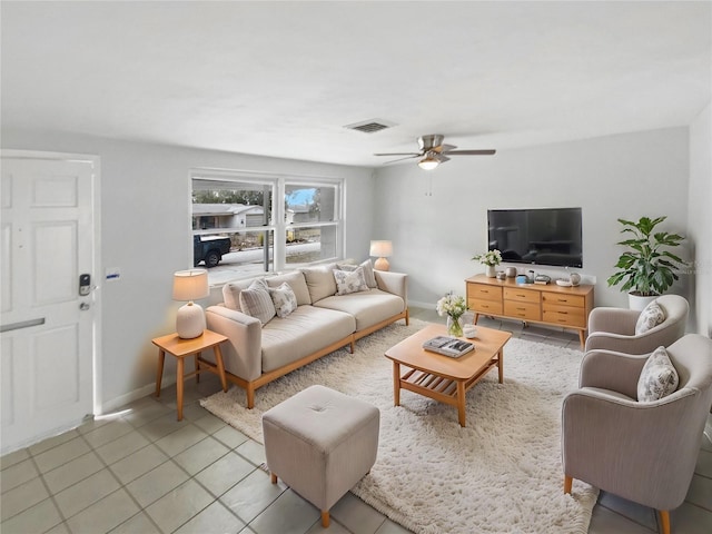 tiled living room featuring ceiling fan