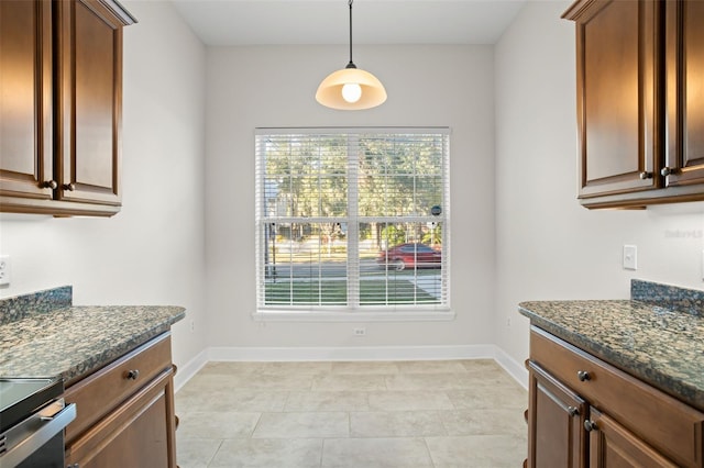 kitchen featuring dark stone countertops and decorative light fixtures