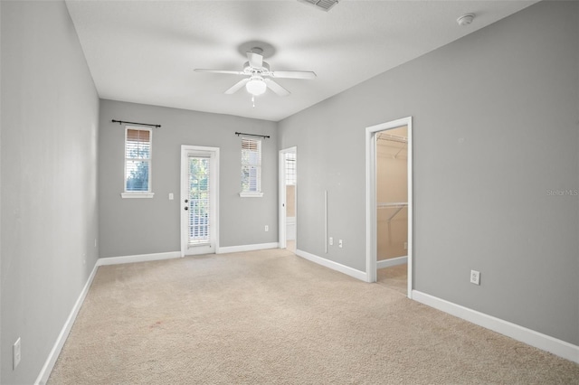 carpeted empty room with ceiling fan