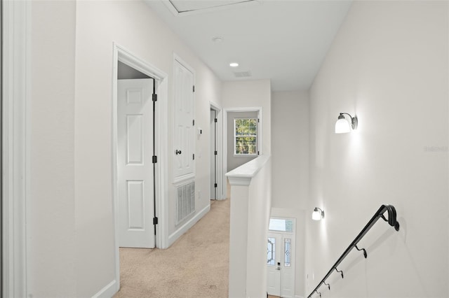 hallway with light colored carpet