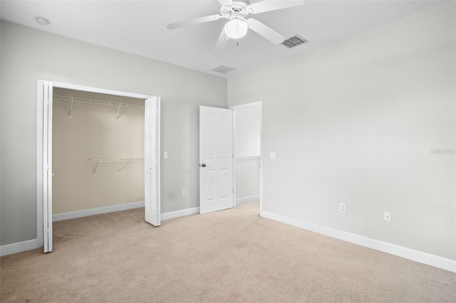 unfurnished bedroom with a closet, ceiling fan, and light colored carpet