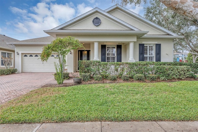 neoclassical home with a garage and a front lawn