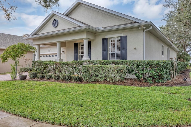 view of front of property with a front yard and a garage