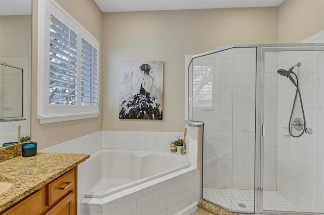 bathroom featuring plus walk in shower and vanity