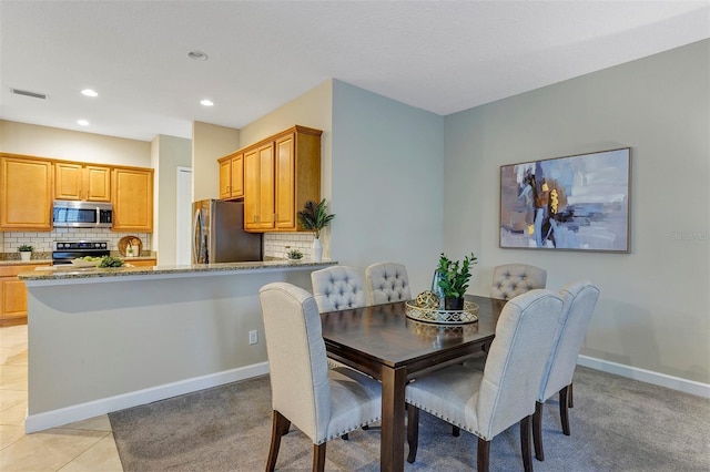 dining area featuring light tile patterned floors