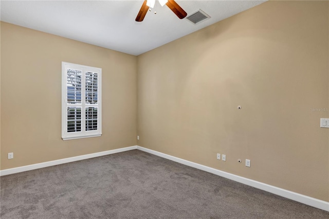 carpeted spare room with ceiling fan