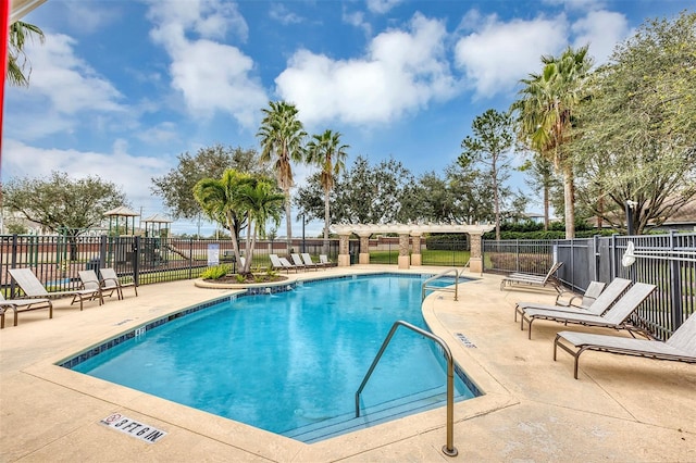 view of swimming pool with a patio area and a pergola