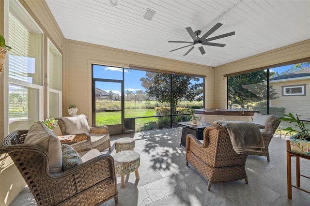 sunroom / solarium with ceiling fan and a healthy amount of sunlight