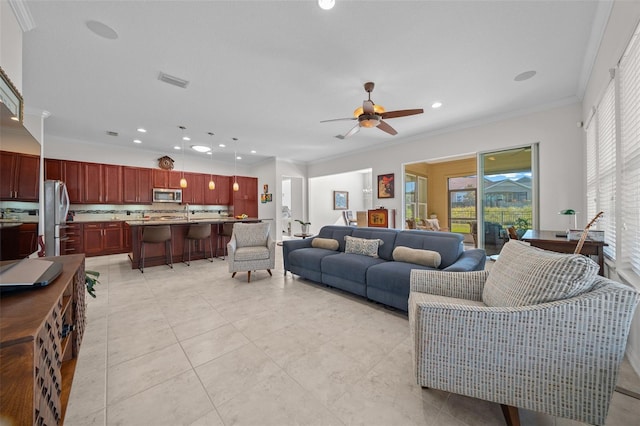 tiled living room with ceiling fan and ornamental molding