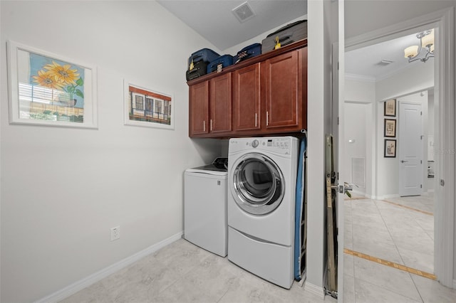 washroom with washer and clothes dryer, light tile patterned floors, and cabinets