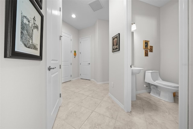 hallway featuring light tile patterned floors