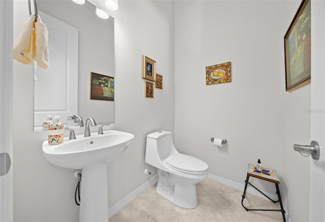 bathroom with tile patterned flooring, toilet, and sink