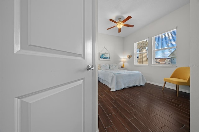 bedroom featuring ceiling fan and dark wood-type flooring