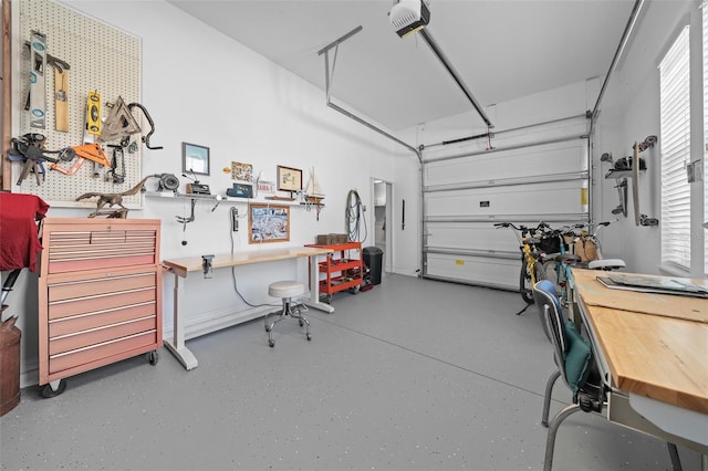 garage with a workshop area and a garage door opener