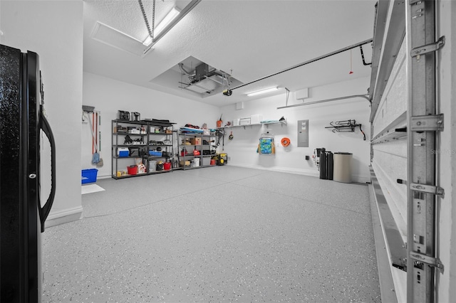 garage featuring electric panel and black fridge