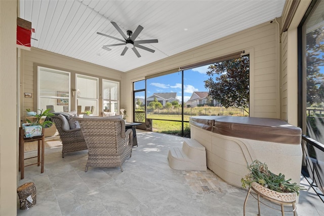 sunroom / solarium featuring a hot tub and ceiling fan