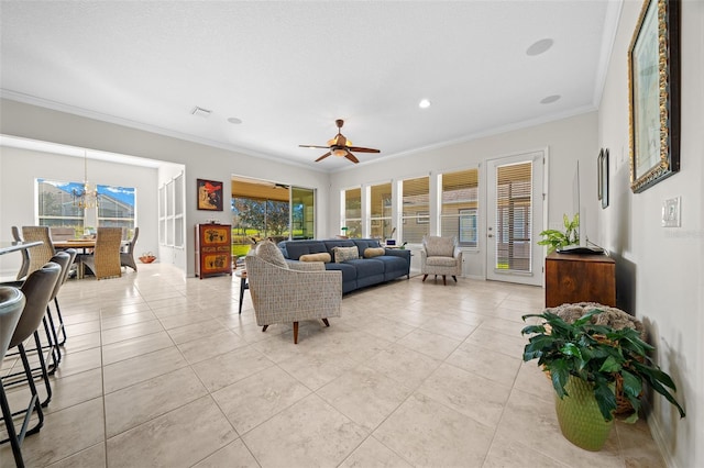 tiled living room featuring plenty of natural light, crown molding, and ceiling fan with notable chandelier