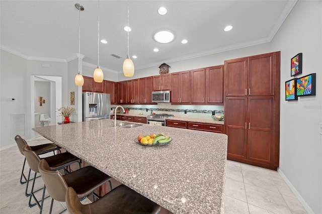 kitchen featuring sink, tasteful backsplash, decorative light fixtures, a breakfast bar area, and appliances with stainless steel finishes