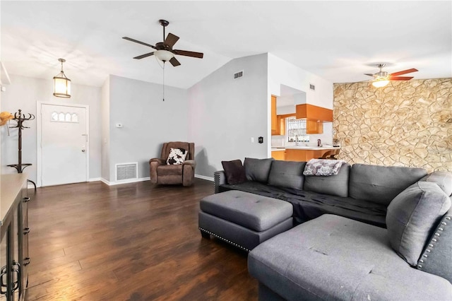 living room featuring dark wood-type flooring, ceiling fan, and lofted ceiling