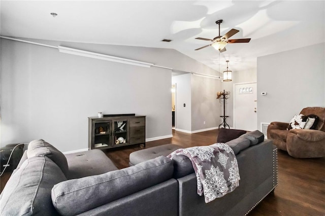 living room featuring ceiling fan, dark hardwood / wood-style flooring, and vaulted ceiling