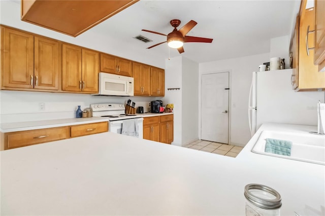 kitchen with sink, white appliances, light tile patterned floors, and ceiling fan