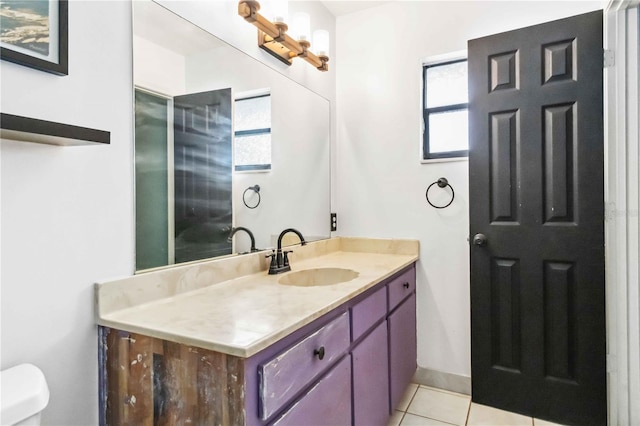 bathroom featuring tile patterned floors, toilet, and vanity