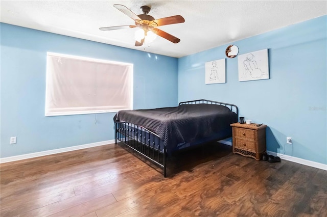 bedroom with ceiling fan and wood-type flooring