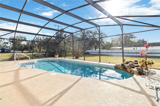 view of swimming pool with glass enclosure and a patio area