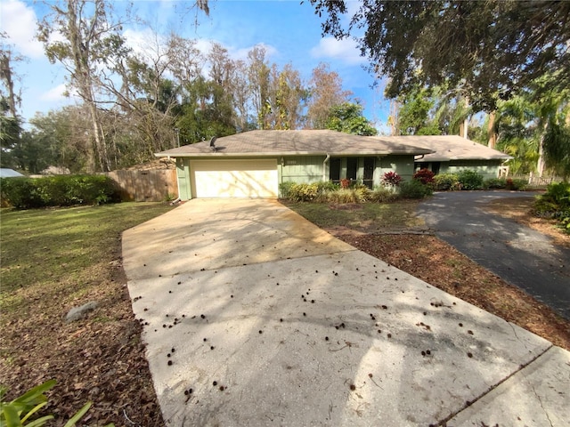 ranch-style house with a garage and a front lawn