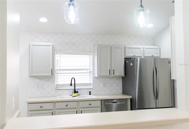 kitchen with stainless steel appliances, decorative light fixtures, decorative backsplash, and sink