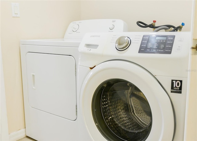 washroom with independent washer and dryer