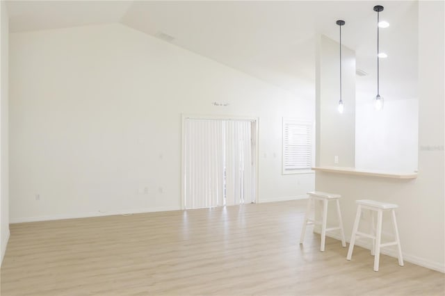 interior space featuring lofted ceiling and light wood-type flooring