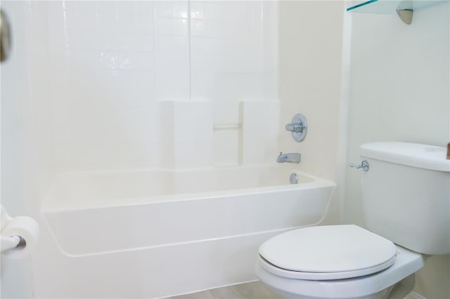 bathroom featuring toilet and  shower combination