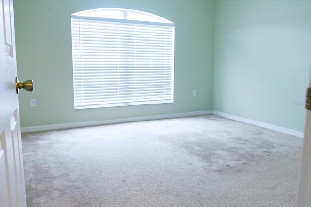 spare room with light colored carpet