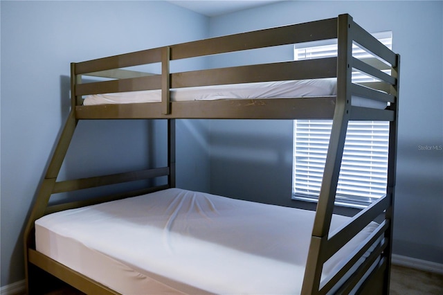 unfurnished bedroom featuring carpet flooring and multiple windows