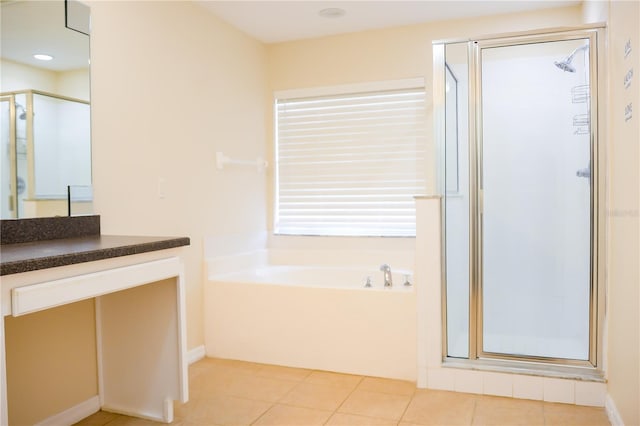 bathroom featuring tile patterned floors, independent shower and bath, and vanity