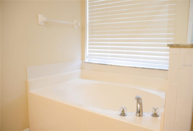 bathroom featuring a relaxing tiled tub