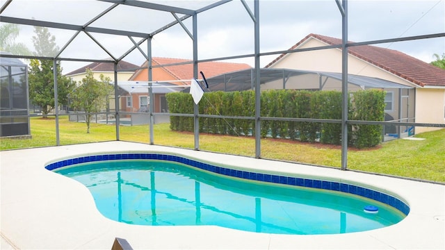 view of swimming pool featuring a lanai and a lawn