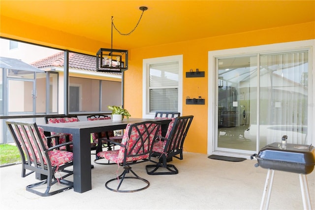 view of patio featuring glass enclosure