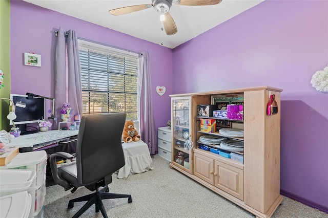 carpeted office featuring ceiling fan