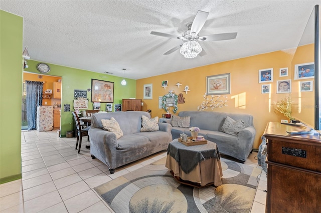 living room with a textured ceiling, light tile patterned flooring, and a ceiling fan