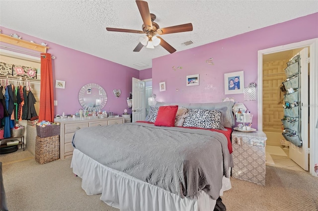 bedroom with light carpet, a closet, visible vents, and a textured ceiling