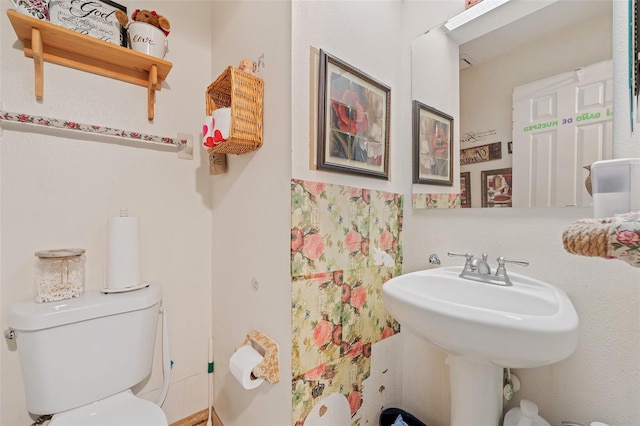 bathroom featuring toilet and a sink