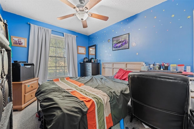 carpeted bedroom featuring a textured ceiling, ceiling fan, an accent wall, and wallpapered walls