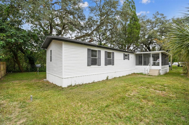 exterior space featuring a sunroom and a yard