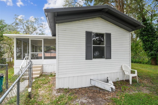 view of property exterior featuring a sunroom