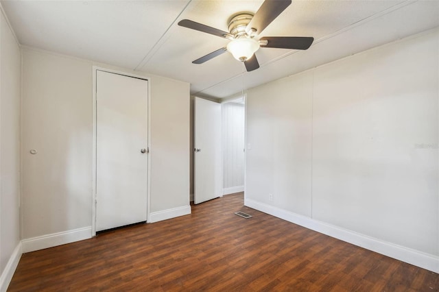 unfurnished bedroom featuring dark hardwood / wood-style flooring and ceiling fan