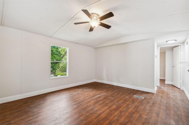 unfurnished room featuring dark hardwood / wood-style flooring, vaulted ceiling, and ceiling fan